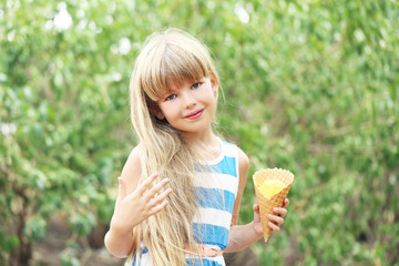 Portrait of  little girl with ice-cream in the park
