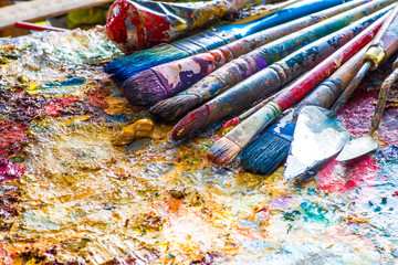 oil paints and paint brushes on a palette