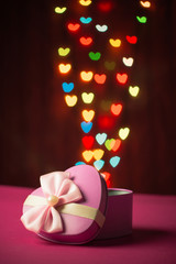 Pink gift box open shaped heart with Defocused bokeh colorful li