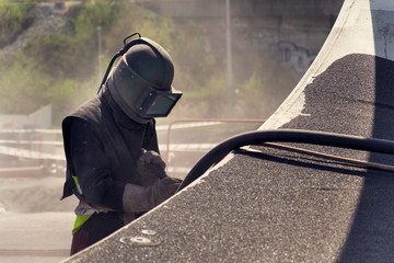 Man with helmet like robot working on a bridge construction - obrazy, fototapety, plakaty
