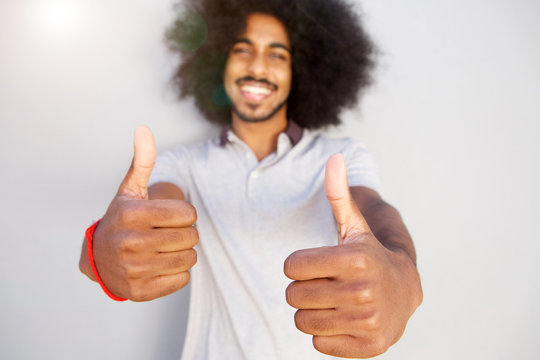 laughing afro man with two thumbs up