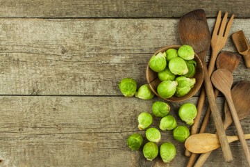 Brussels sprouts on old wooden table. Homework fresh vegetables. Growing vegetables on the farm. Preparing vegetarian food. Diet food.