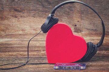 Romantic music concept - red heart with headphones, retro toned