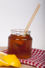 Honey in jar on a wooden background