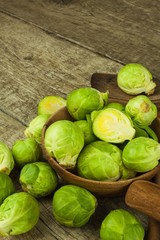 Brussels sprouts on old wooden table. Homework fresh vegetables. Growing vegetables on the farm. Preparing vegetarian food. Diet food.