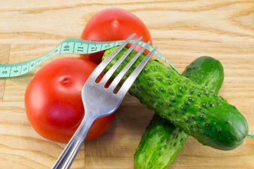 Cucumber and tomato with measuring