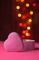 Pink gift box open shaped heart with Defocused bokeh colorful li
