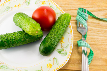 Cucumber and tomato with measuring