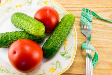 Cucumber and tomato with measuring