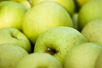 Group green apples in a basket