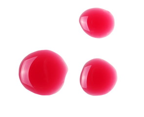 Glossy red wine liquid droplets isolated on white