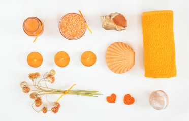 Spa attributes sets. Honey bath salts, dry flowers, soap, cosmetic cream, cosmetic oil, candles, shell, stone and towel. Yellow orange concept. Flat lay on white background top view.