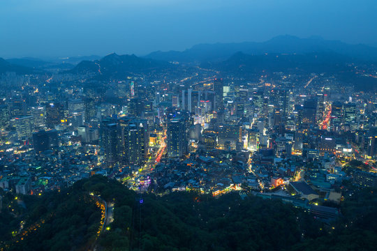 View of Namsan Hill and downtown in Seoul, South Korea, from above at dusk.