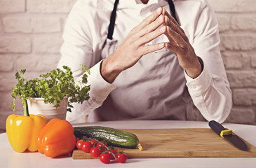 Chef's hands. Man is ready to prepare fresh salad.