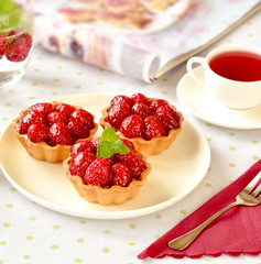 Tiny cupcakes with red berries