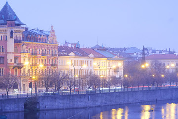 Prague, Czechia - November, 21, 2016: Panorama of an old Prague, bridges and embankment of Vitava river in an evening, Czechia