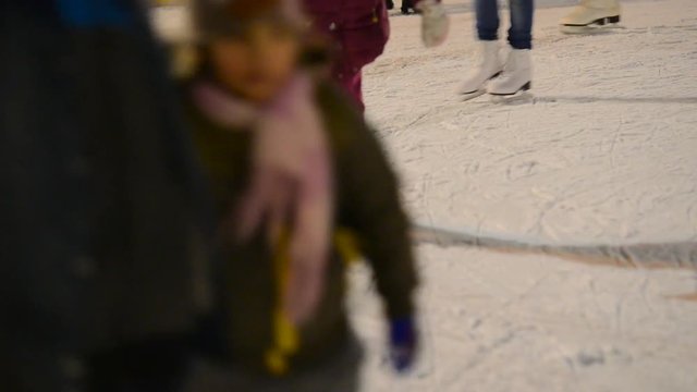Ice-skaters in the outdoor stadium. real time, no sound,shallow depth of field