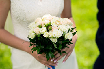 wedding bouquet in hands of the bride