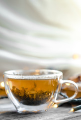 Transparent Cup of tea on wooden background