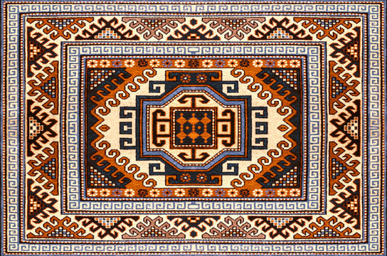 Bright woolen carpet with ethnic folk geometric pattern in red and  blue shades
