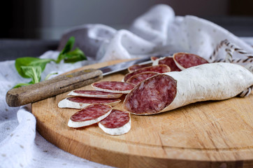 Salami on the kitchen Board, cut into slices