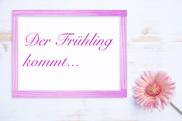 pink flower and frame with german words for Spring Is Coming
