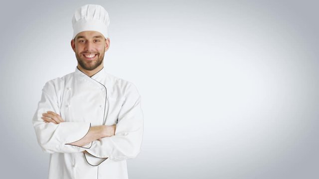 Mid Shot of a Handsome Chef Crossing Arms and Smiling. Shot with White Background.  Shot on RED Cinema Camera 4K (UHD).