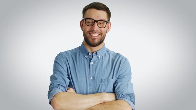 Mid Shot of a Stylish Young Man Correcting His Glasses and Crossing Arms. Shot with White Background.  Shot on RED Cinema Camera 4K (UHD).