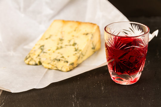 Glass of sloe gin with stilton cheese