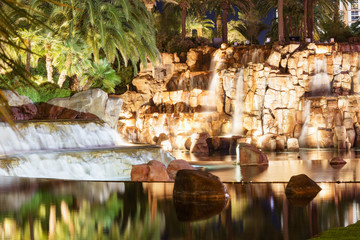 Fountain is in Las Vegas. Night city landscape with waterfall. 