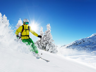 Skier on piste running downhill