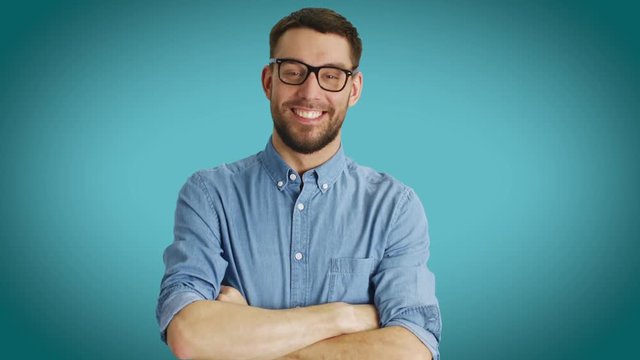 Mid Shot of Fashionable Handsome Man Correcting His Classes. Shot on a Teal Colored Background.  Shot on RED Cinema Camera 4K (UHD).