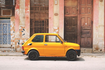Side view of yellow vintage car parked on the street