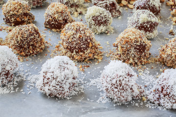 Homemade chocolate truffles on a baking sheet lined with parchment paper.