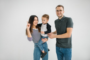 Hipster father, mother holding baby boy over white isolated back