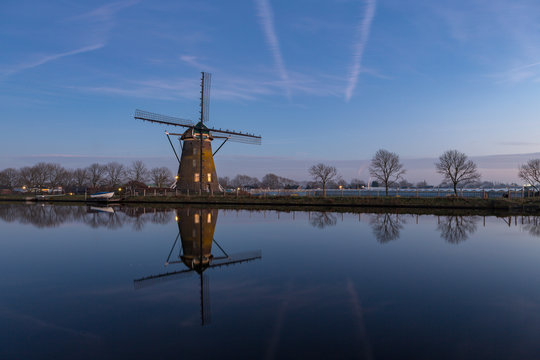 Windmill "the Googermolen" with reflection in the water on the Ringvaart canal in Nieuwe Wetering the Netherlands.