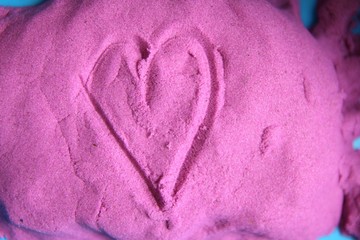 Fun kinetic sand. Child building heart. Sand for Indoor Children Creativity Games Or Beach Games...
