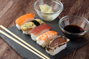 close up of sashimi sushi set with chopsticks and soy - sushi roll with salmon and sushi roll with smoked eel, selective focus.