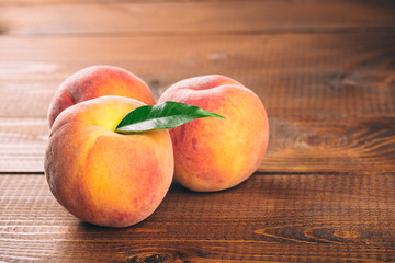 Naklejka na ściany i meble Fresh beautiful fruit peaches on wooden background