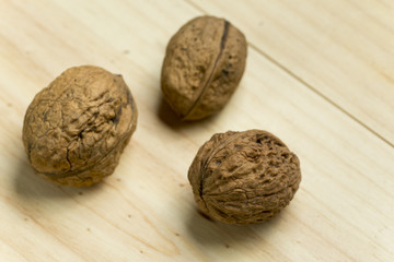 Nuts on a pine wood background.