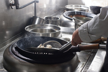 Close up of working chef preparing chinese food