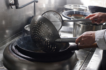 Close up of working chef preparing chinese food