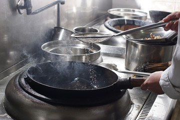 Close up of working chef preparing chinese food