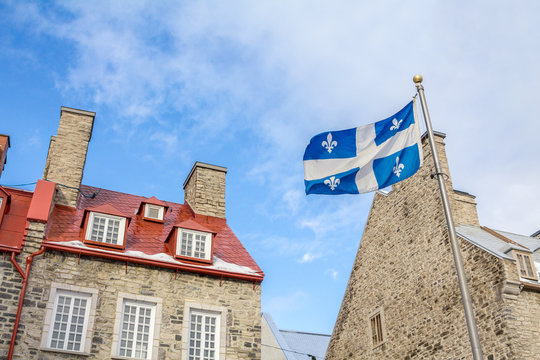 Quebec flag in front of a old house of Quebec City, in the Lower Town (basse ville)