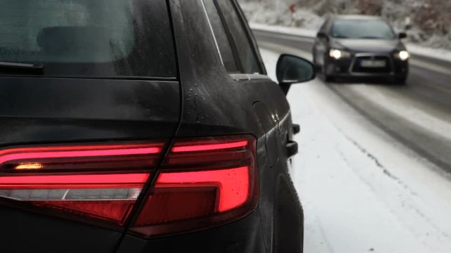 Close-up of car blinker - winter road and traffic