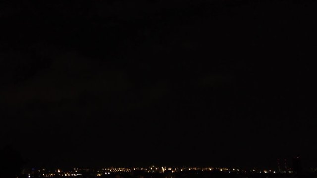 Thunder over city flash of lights in dark night