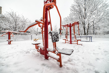 Fototapeta na wymiar Outdoor workout gym with training gear in winter