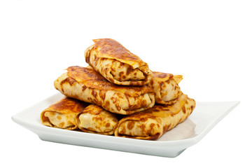 Russian Stuffed Pancakes Blintzes with Meat Isolated on White. Selective focus.