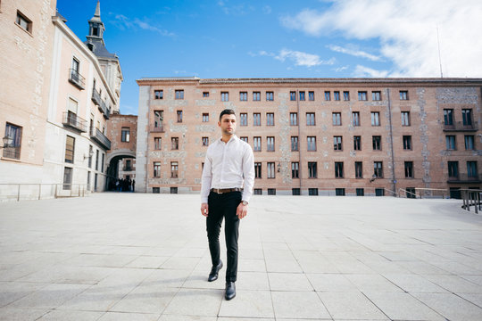 Thoughtful Businessman Walking At Town Square