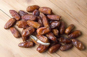 Dried date fruits on wooden table